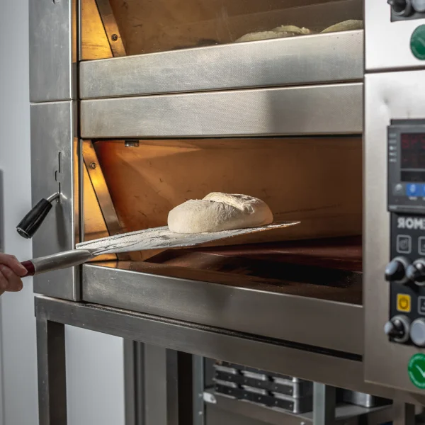 Professional Oven for Your Bakery: Which One to Buy? 3 A professional oven rack filled with various types of freshly baked bread.